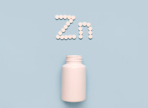 Chemical element Zinc Zn icon from tablets and drug bottle on blue background. Colltction of vitamin and minerals