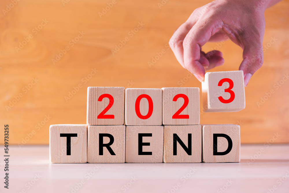 Leinwandbilder hand build stack of wood cube building block with text 2023 trend , new year 2023 plan concept