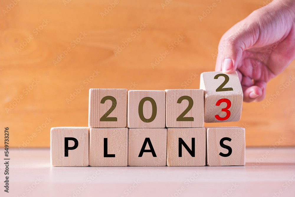 Poster hand build stack of wood cube building block with text 2023 plans , new year 2023 plan concept