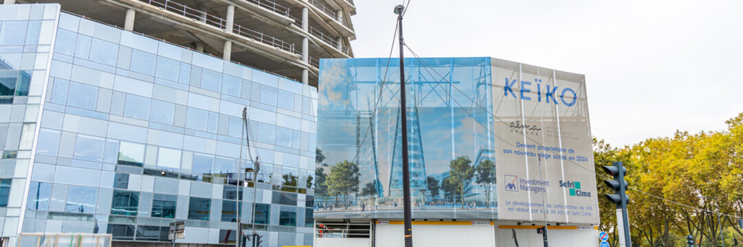 Billboard showing the final image of the Tour KEIKO tower during the construction of the building in Issy-les-Moulineaux, France