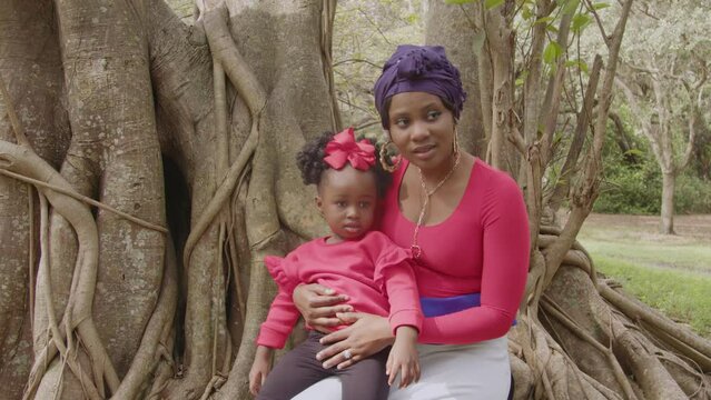 Mother and daughter sitting in tree