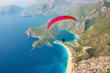Aerial view of paraglider flying above Belcekiz Beach, Oludeniz, Fethiye, Turkey.