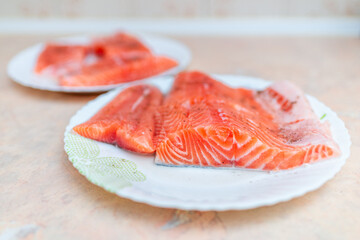 Domestic Raw salmon fillet with spices on the plates.Selective focus.Close-up.