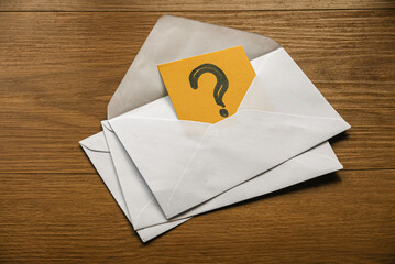 A question symbol inside an envelope. Question and answer concept.