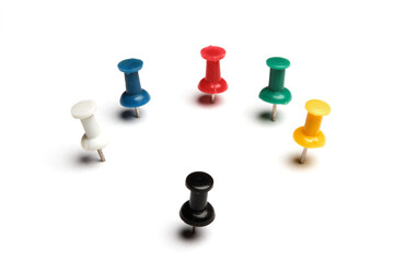 set of real used colored plastic pins with different colors on white background with shadows. Pins with different orientations. 
