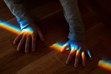 Natural rainbow on the palm of a child. Refraction of light