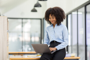Beautiful asian african businesswoman sitting at office desk, 