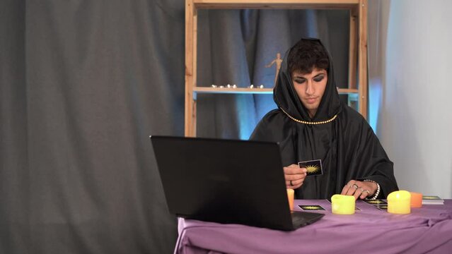 Tarot reader picking tarot cards. Fortune teller reading and forecasting online concept.