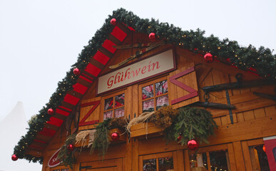 Christmas market in Berlin, Germany. Gluhwein Hot Mulled Wine Sign plate at Famous outdoor Christmas Market in Berlin on old building background.