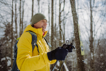 Senior man admiring nature during cross country skiing.
