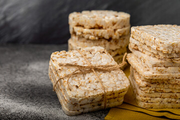 Rice cakes on a black table. Bread. Airy rice bread. dietary crispy round rice cakes. Place for text. Place to copy. Healthy food. dietary product.