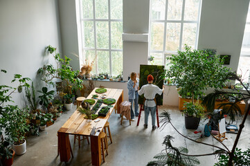 Floral design studio view with florists making decorations view from afar