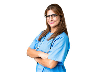 Middle age nurse woman over isolated background with arms crossed and looking forward