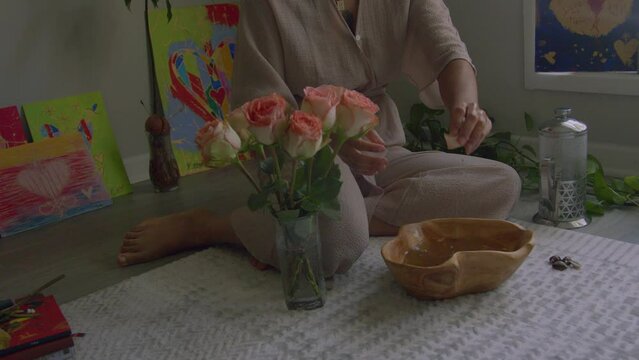 Young woman putting on floral herbal wash