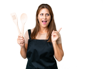 Middle age caucasian woman holding a rolling pin over isolated background intending to realizes the solution while lifting a finger up