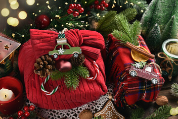 Christmas presents wrapped in creative way in front of Christmas tree