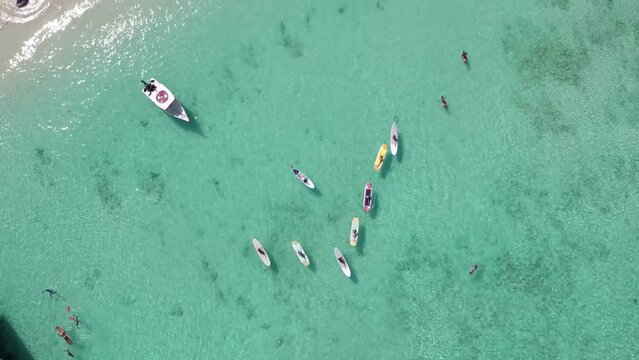 People enjoying the beach in tropics. Aerial view.