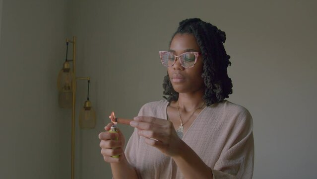 Young woman lighting incense 