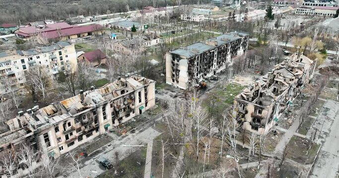 Drone flying over a destroyed district. Roofs of the buildings in the city in ruins - an aerial view with a drone