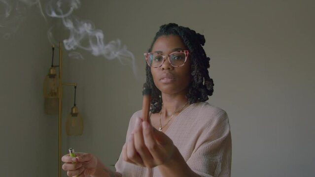 Young woman burning incense 