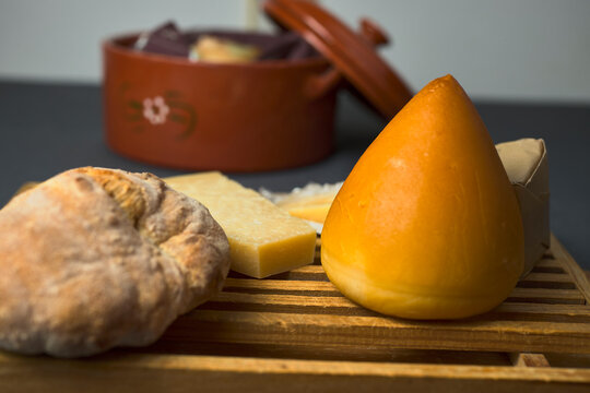 Cheeseboard. In the foreground a cheese from San Sim&oacute;n, called in the form of a tetilla