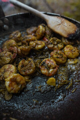 Campfire  smoking salmon in pan, near the fire outdoors. bushcraft, adventure, tea, knife and camping concept