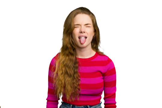 Young caucasian redhead woman isolated funny and friendly sticking out tongue.