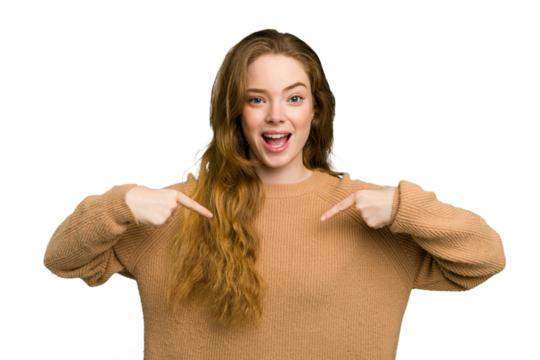 Young caucasian redhead woman isolated surprised pointing with finger, smiling broadly.