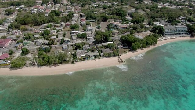 A coastal line of Barbados with with city beach and village