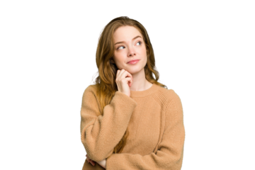 Young caucasian redhead woman isolated thinking and looking up, being reflective, contemplating, having a fantasy.