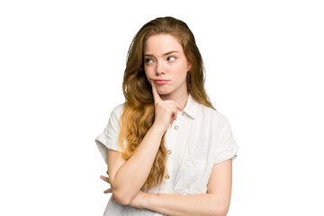Young caucasian redhead woman isolated looking sideways with doubtful and skeptical expression.