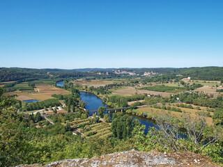 Fototapeta na wymiar Dordogne valley. A magnificent panorama from the Promenade des Falaises to the Dordogne river and its winding course in the valley from The Bastide of Domme