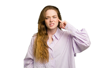 Young caucasian redhead woman isolated covering ears with fingers, stressed and desperate by a loudly ambient.