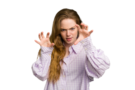 Young caucasian redhead woman isolated showing claws imitating a cat, aggressive gesture.