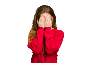 Young caucasian redhead woman isolated blink at the camera through fingers, embarrassed covering face.