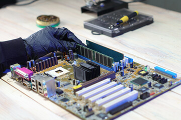 inserting ram into motherboard from computer on table