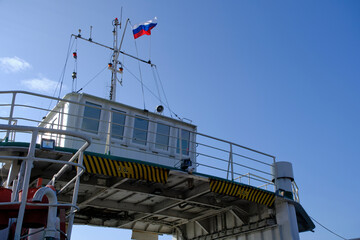 Captain cabin on ferry with Russian flag.