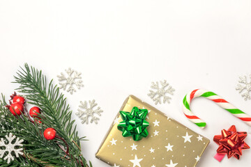 Christmas red and green background with copy space, chritmas tree and red berries holly, presents,...