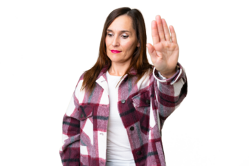 Middle age woman over isolated chroma key background making stop gesture and disappointed