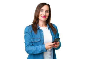 Middle age woman over isolated chroma key background sending a message with the mobile