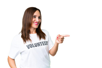 Middle age volunteer woman over isolated chroma key background pointing finger to the side and...