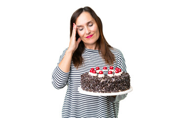 Middle age caucasian woman holding birthday cake over isolated chroma key background with headache