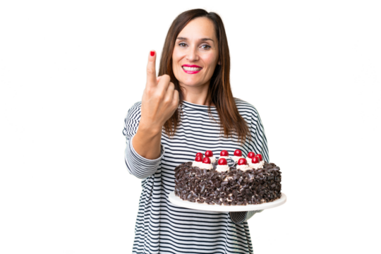 Middle age caucasian woman holding birthday cake over isolated chroma key background doing coming gesture
