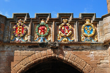Colourful Carved Heraldic Emblems over Entrance Gate to Old Scottish Castle 