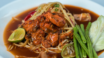 Spicy papaya salad with pickled shells. It is recommend  Thai food