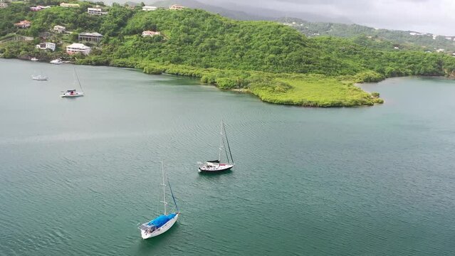 Moored yacht in turquoise lagoon near tropical island