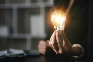 Person hold glowing light bulb, Creative new idea. Innovation, brainstorming, strategizing to make the business grow and be profitable. Concept execution, strategy planning and profit management