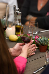 Woman holding wine glass at restaurant table