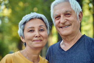 Optimistic active old 60s couple in love pose outdoor