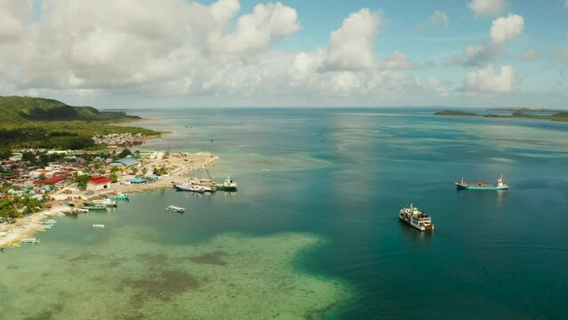 Freight ships and ferries in the bay, top view. Dapa Ferry Terminal. Siargao, Philippines.